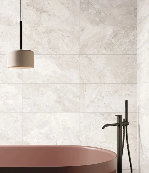 Dreamy Cream marble-look porcelain wall tiles installed in a contemporary bathroom with freestanding bath