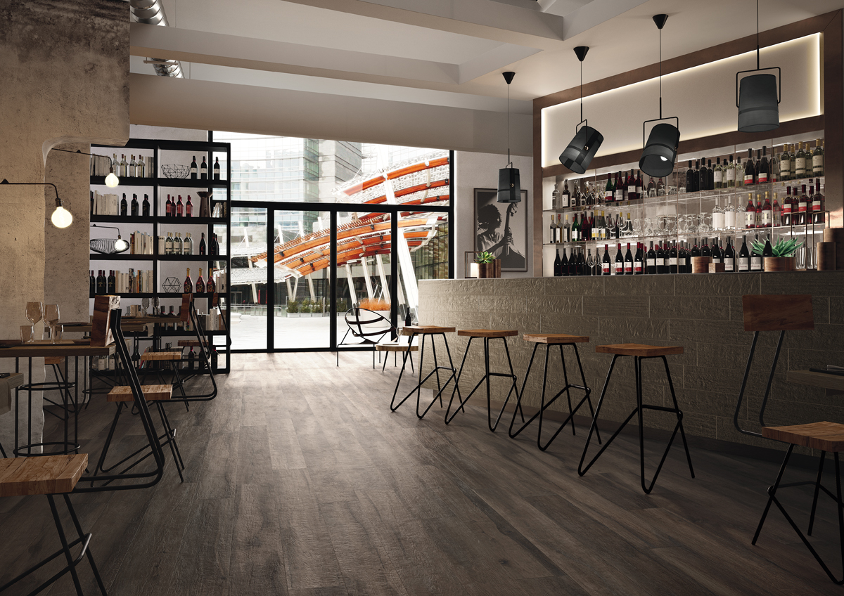 Kuni Black timber look porcelain floor tile in a modern dining room with dark wood grain texture
