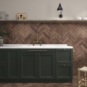 Magnetism Corten Bronze metallic-look matt ceramic wall tile 63x250mm installed in a herringbone pattern as a contemporary kitchen splashback.