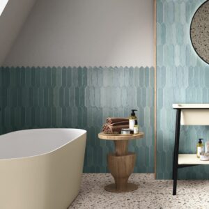 Modern Aqua Sea gloss picket tiles in a contemporary bathroom featuring blue-green wall tiles, terrazzo flooring, timber accents, and a round mirror.